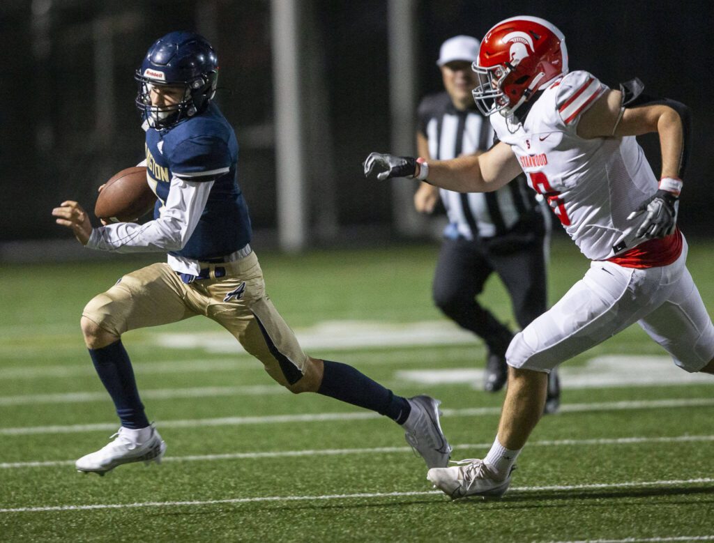 Arlington’s Leyton Martin runs the ball during the Stilly Cup rivalry game against Stanwood Sept. 30, 2022, in Arlington. (Olivia Vanni / The Herald)
