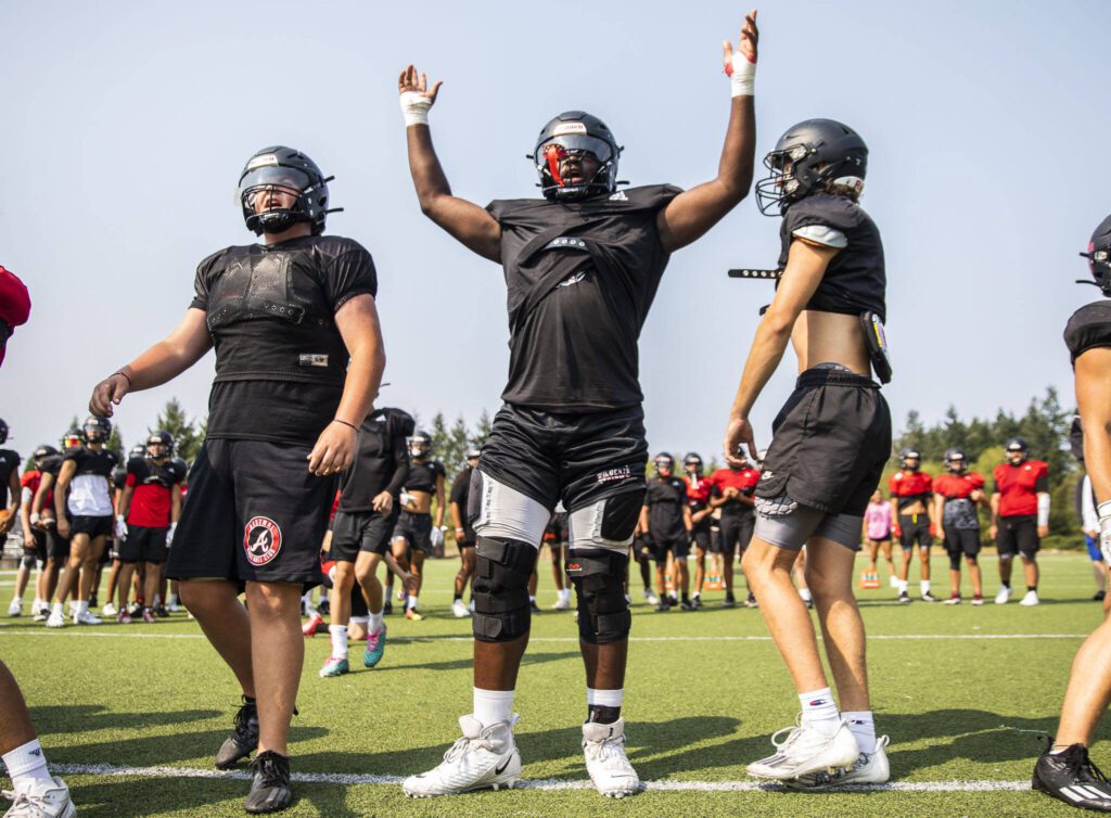 Archbishop Murphy’s Hakeim Smalls lifts his arms and cheers after their kicker makes a field goal during practice on Thursday, Aug. 24, 2023 in Everett, Washington. (Olivia Vanni / The Herald)

