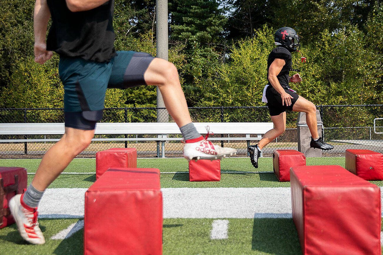 Archbishop Murphy football players run through warm ups during practice on Thursday, Aug. 24, 2023 in Everett, Washington. (Olivia Vanni / The Herald)