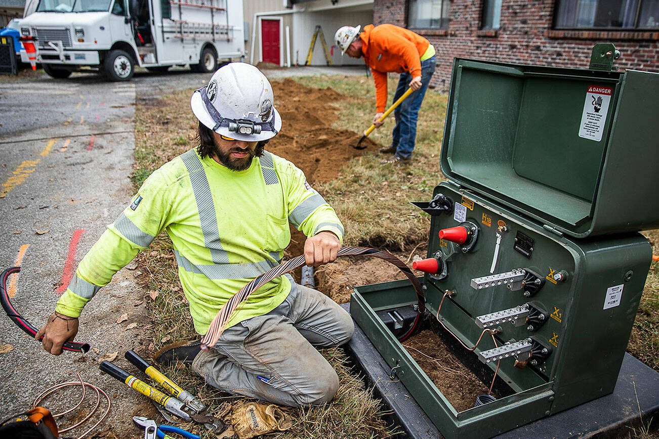 Cole Riccardo works on setting up new underground power lines on Thursday, Aug. 31, 2023 in Arlington, Washington. (Olivia Vanni / The Herald)