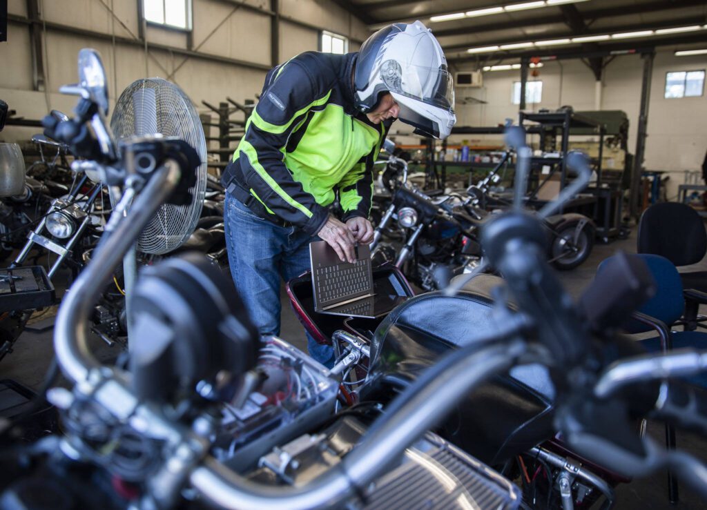 Bill Messing plugs in his computer to look through data after a quick ride on Wednesday, Aug. 16, 2023 in Granite Falls, Washington. (Olivia Vanni / The Herald)
