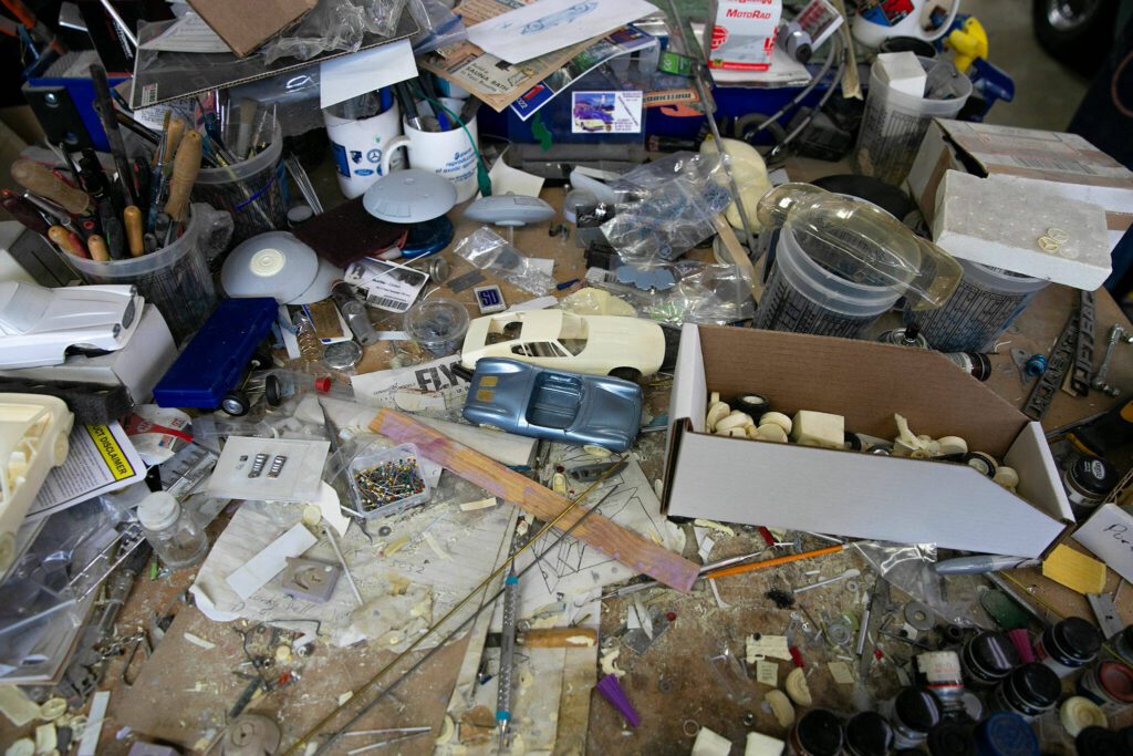 A model workbench used by Jim Simpson is cluttered from years of use on Friday, August 25, 2023, in Clinton, Washington. (Ryan Berry / The Herald)
