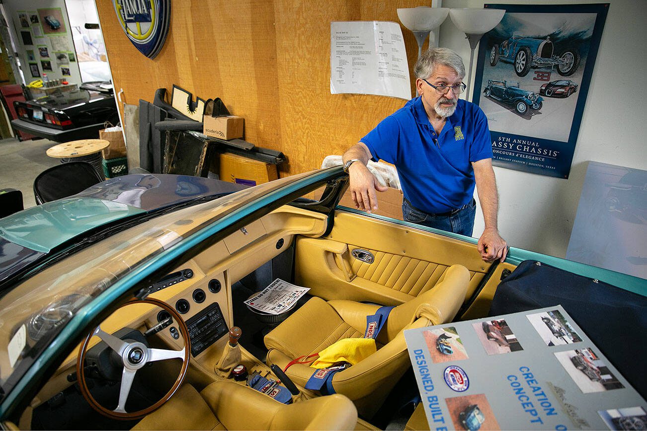 Jim Simpson leans on Blue Ray III, one of his designs, in his shop on Friday, August 25, 2023, in Clinton, Washington. (Ryan Berry / The Herald)