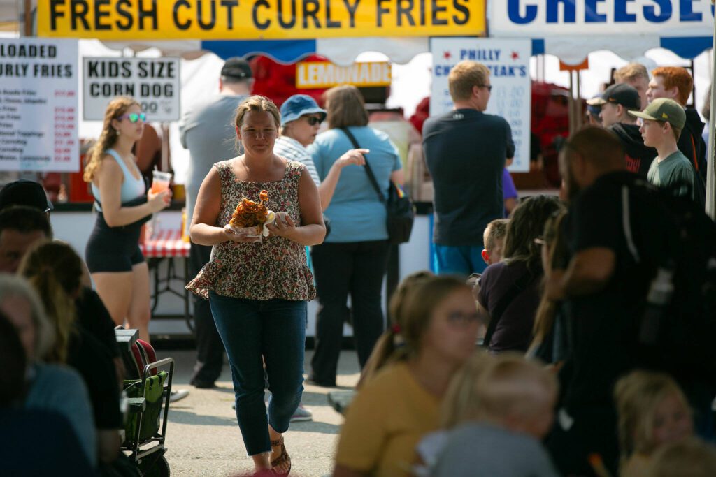 The food court begins to swell with customers as people grab lunch during opening day of the Evergreen State Fair on Thursday, August 24, 2023, in Monroe, Washington. (Ryan Berry / The Herald)
