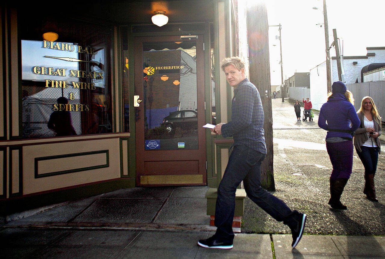 Celebrity chef Gordon Ramsay hurriedly walks into the Prohibition Grille on Dec. 5, 2012 while filming an episode of “Kitchen Nightmares” to makeover the struggling downtown Everett restaurant. (Mark Mulligan / The Herald)