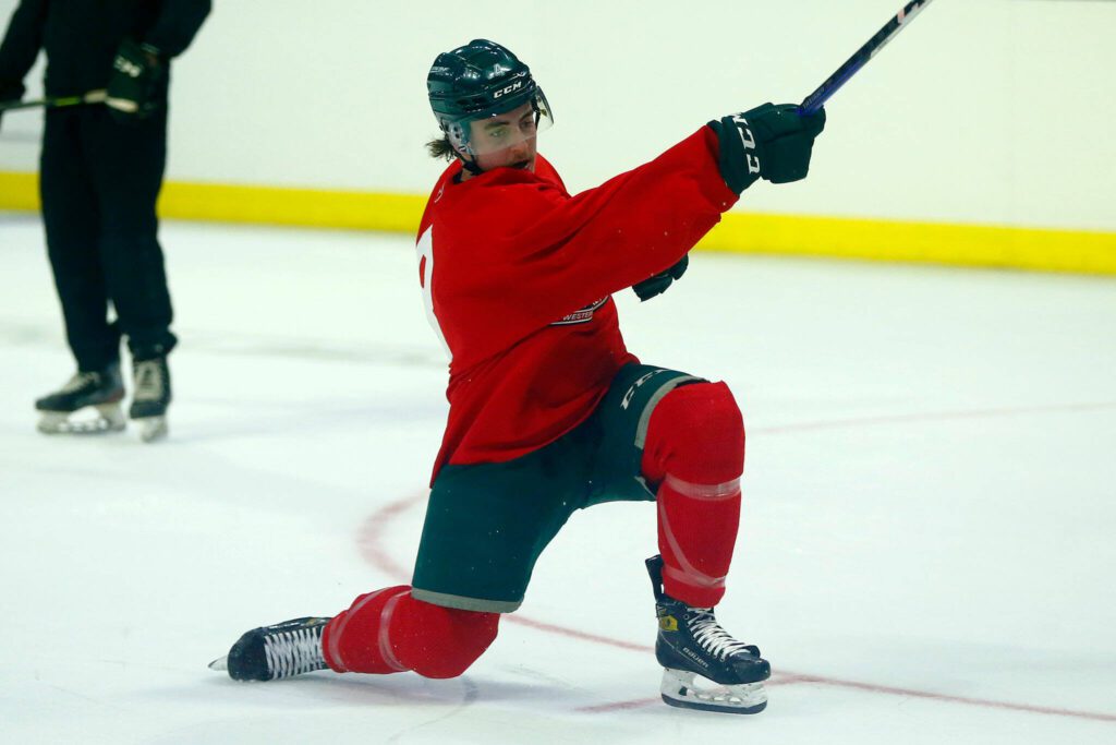 Dexter Whittle goes down to a knee on a slap shot during the first day of Silvertips training camp on Thursday, August 31, 2023, at Angel of the Winds Arena in Everett, Washington. (Ryan Berry / The Herald)
