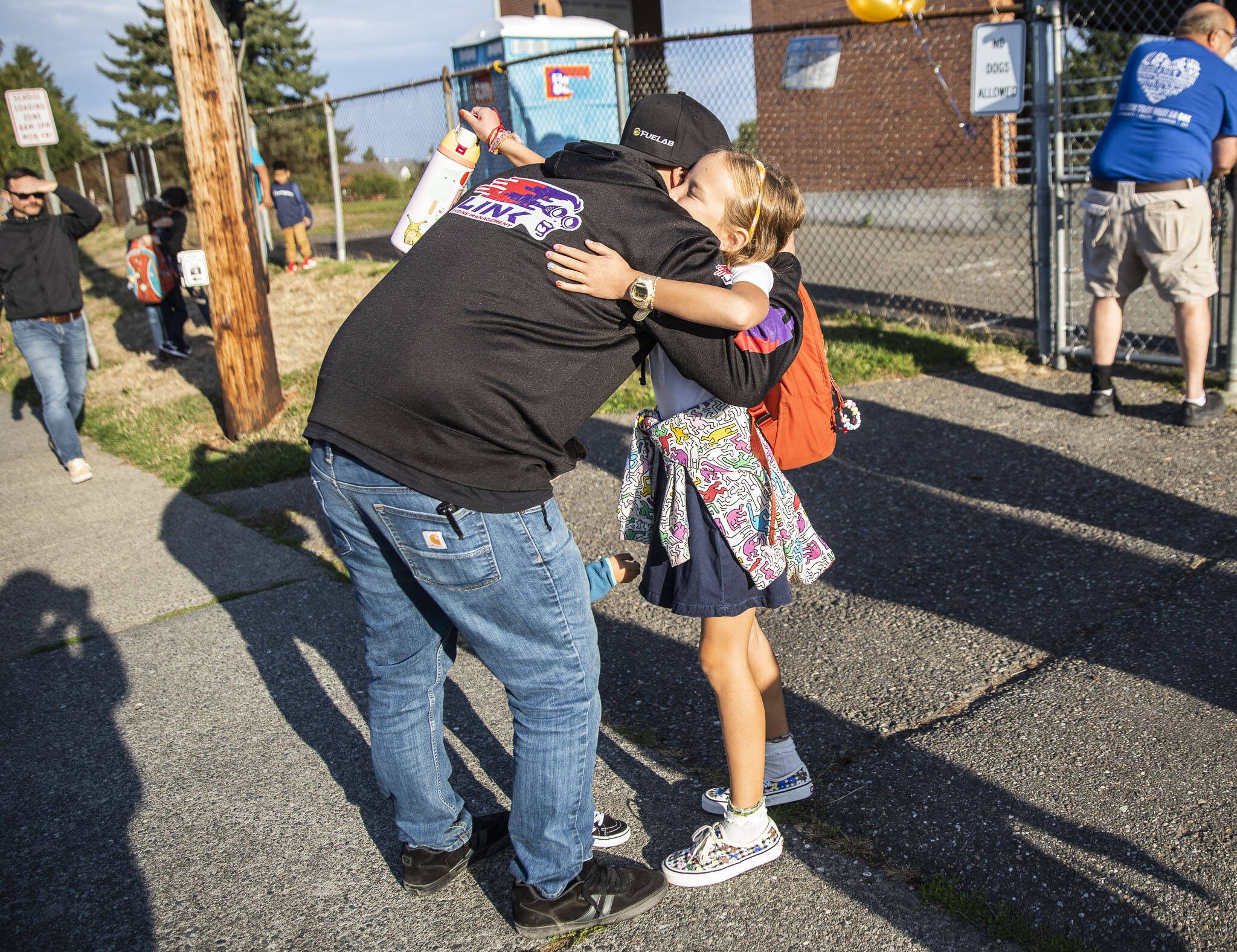 Ray Stonehocker hugs his daughter Kinley before she leaves to start her first day for fourth grade at Whittier Elementary on Wednesday, Sept. 6, 2023 in Everett, Washington. (Olivia Vanni / The Herald)