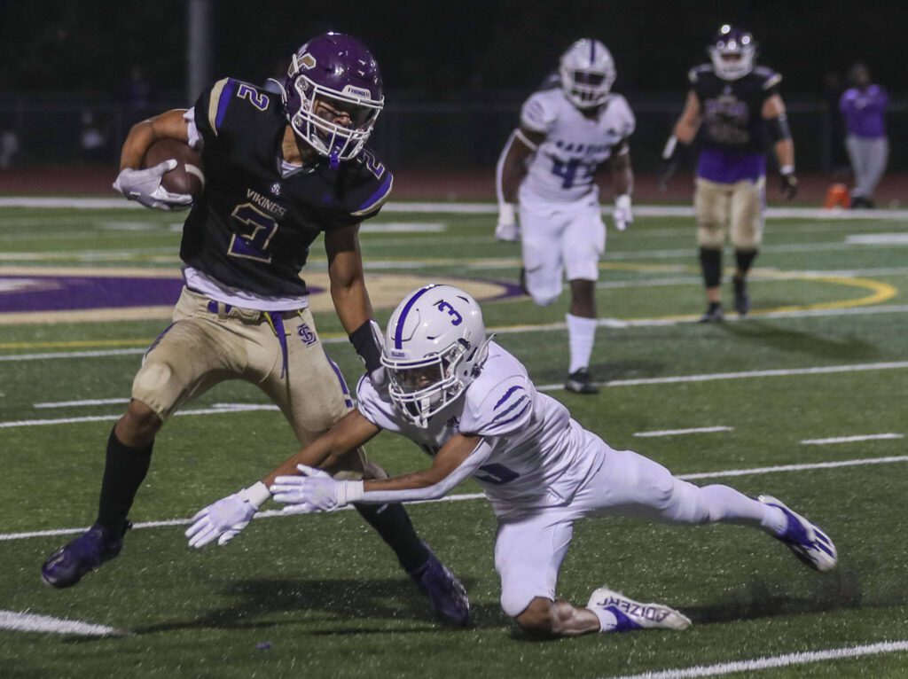 Lake Stevens’ Steven Lee (2) dodges a tackle during a football game between Lake Stevens and Garfield at Lake Stevens High School in Lake Stevens, Washington on Friday, Sept. 1, 2023. The Vikings won 48-21. (Annie Barker / The Herald)
