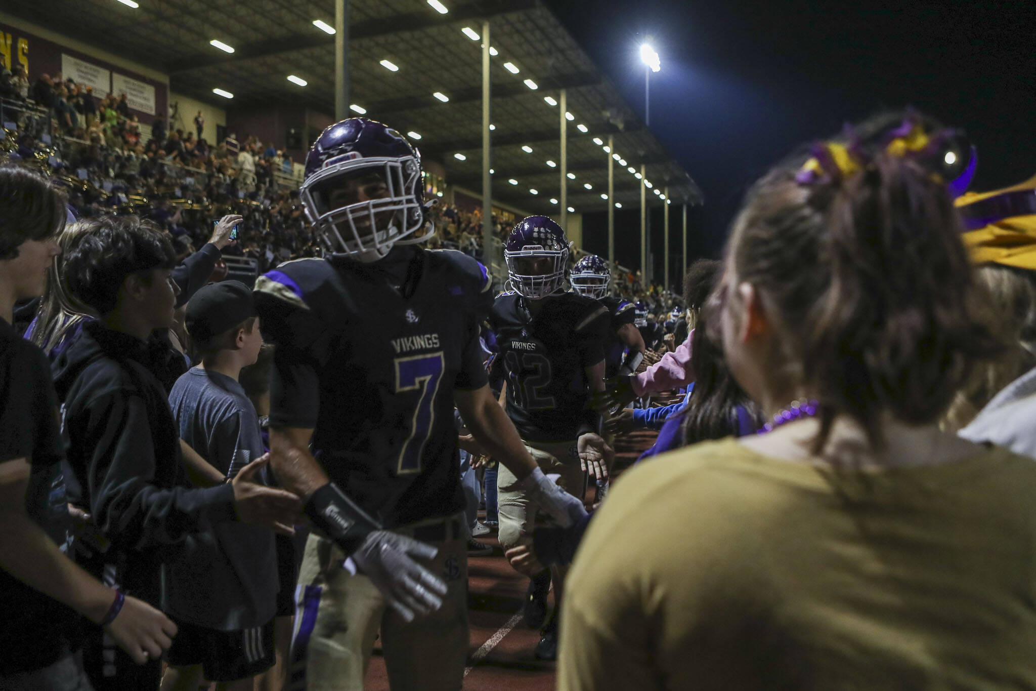 Lake Stevens players run through a tunnel after a football game between Lake Stevens and Garfield at Lake Stevens High School in Lake Stevens, Washington on Friday, Sept. 1, 2023. Lake Stevens lead 20-7 at the half. The Vikings took the win, 48-21. (Annie Barker / The Herald)