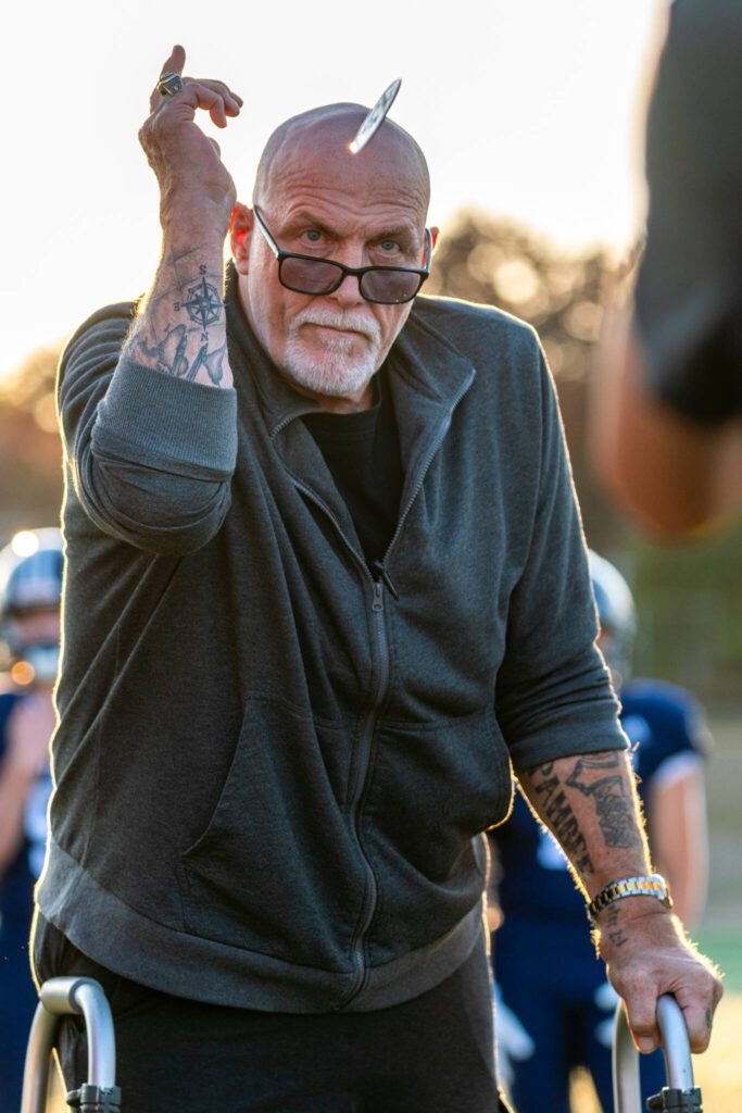 Curt Marsh, 1976 High School All-American football player for the Snohomish state championship football team, flips the game coin before a game between Snohomish and Glacier Peak on Sept. 1, 2023, at Snohomish High School. (John Gardner / Pro Action Image)
