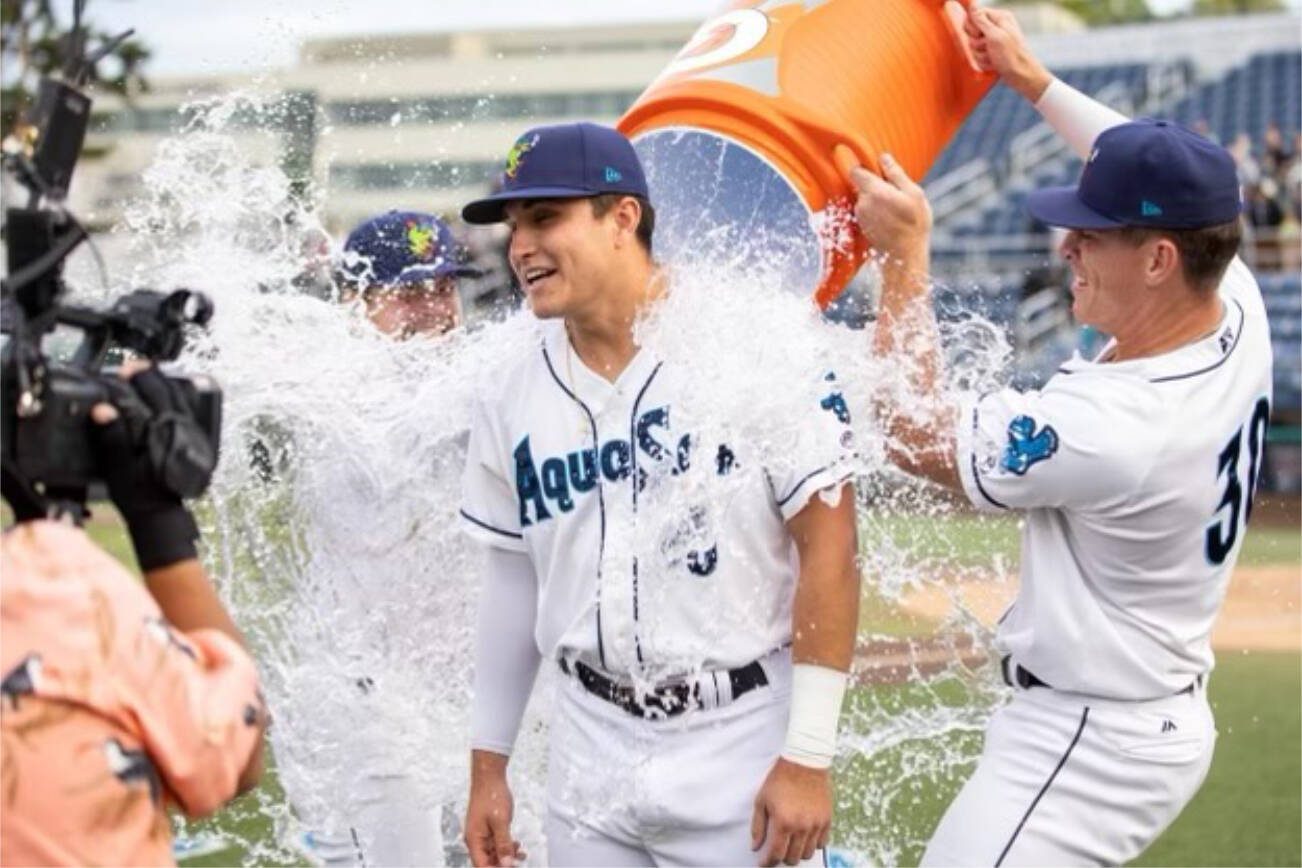 Ben Ramirez is doused with water by teammates after the AquaSox beat the Emeralds to clinch a playoff berth on Monday, Sept. 4, 2023, in Everett. (Photo provided by AquaSox)