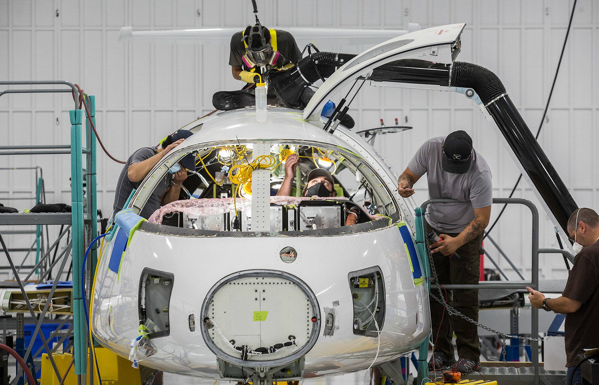 Workers build the first all-electric commuter plane, the Eviation Alice, at Eviation’s plant on Wednesday, Sept. 8, 2021 in Arlington, Washington. (Andy Bronson / The Herald)
