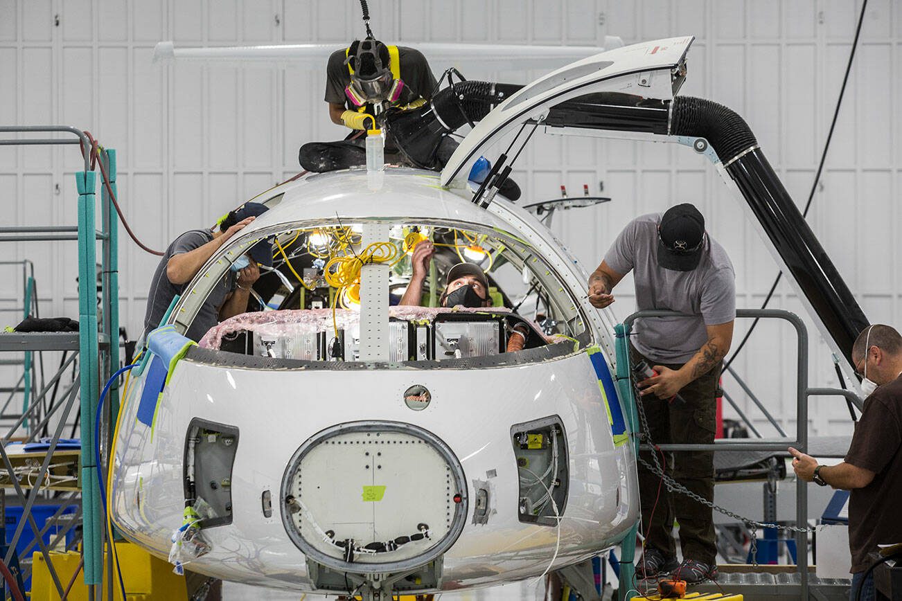 Workers build the first all-electric commuter plane, the Eviation Alice, at Eviation's plant on Wednesday, Sept. 8, 2021 in Arlington, Washington.  (Andy Bronson / The Herald)