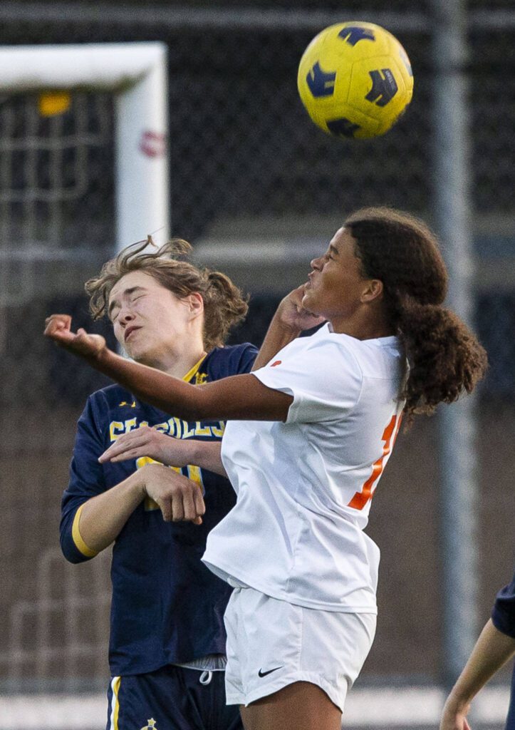 Monroe’s Addison Williams leaps to head the ball during the game against Everett on Thursday, Sept. 7, 2023 in Everett, Washington. (Olivia Vanni / The Herald)
