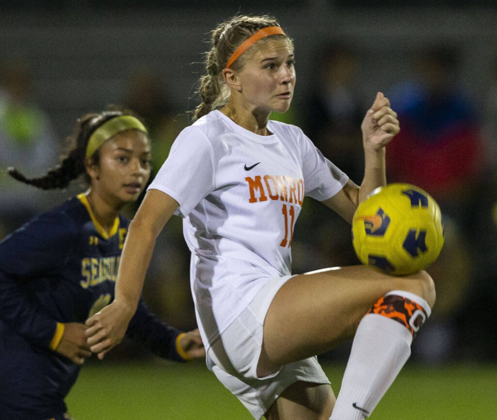 Monroe’s Sydney Garner jumps to trap the ball during the game against Everett on Thursday, Sept. 7, 2023 in Everett, Washington. (Olivia Vanni / The Herald)
