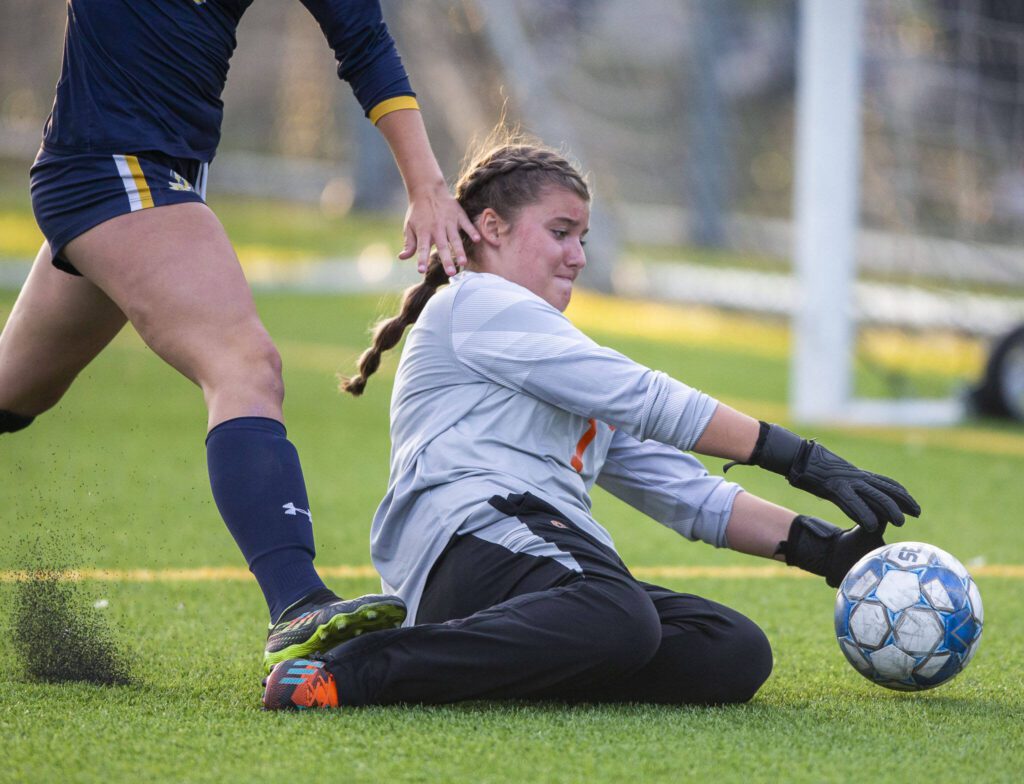 Monroe’s Brooklyn Krache slides to grab a loose ball in the box during the game against Everett on Thursday, Sept. 7, 2023 in Everett, Washington. (Olivia Vanni / The Herald)
