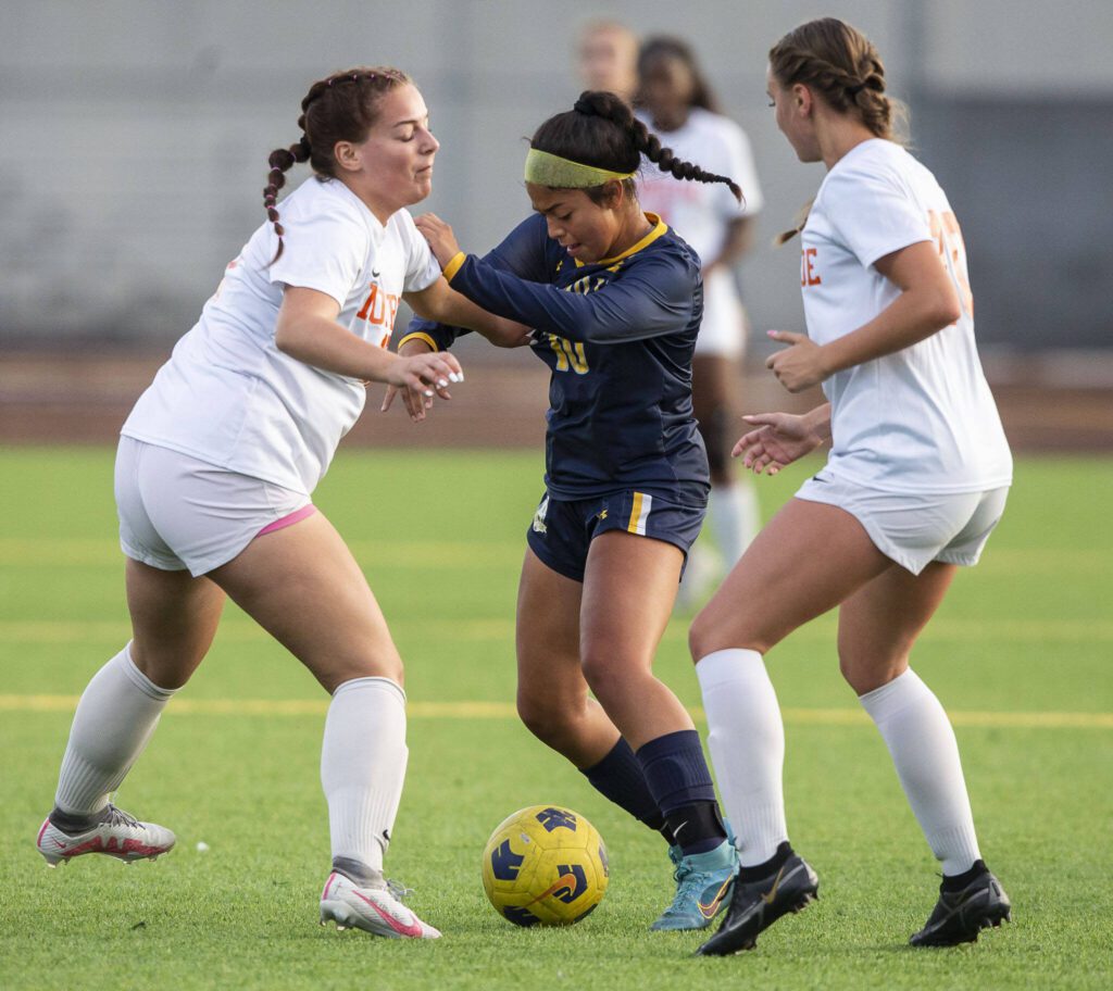 Everett’s Genesis Molina Escobar tries to dribble around multiple Monroe players during the game on Thursday, Sept. 7, 2023 in Everett, Washington. (Olivia Vanni / The Herald)
