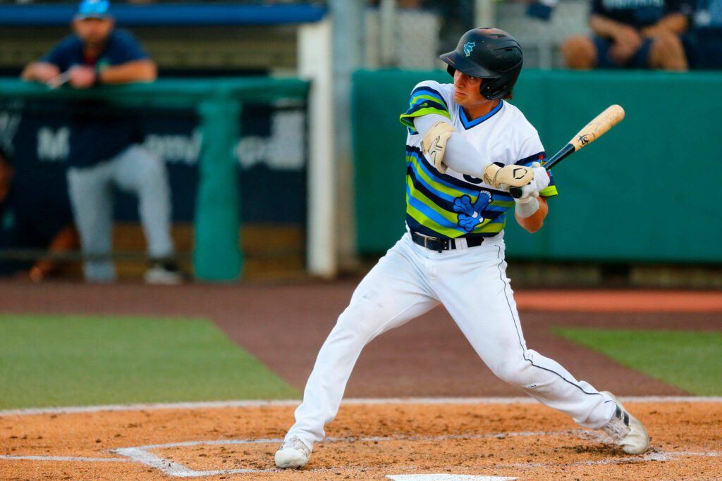 AquaSox shortstop Cole Young, one of Seattle’s top prospects, steps into a swing while batting during a game against Hillsboro on Thursday, August 17, 2023, at Funko Field in Everett, Washington. (Ryan Berry / The Herald)
