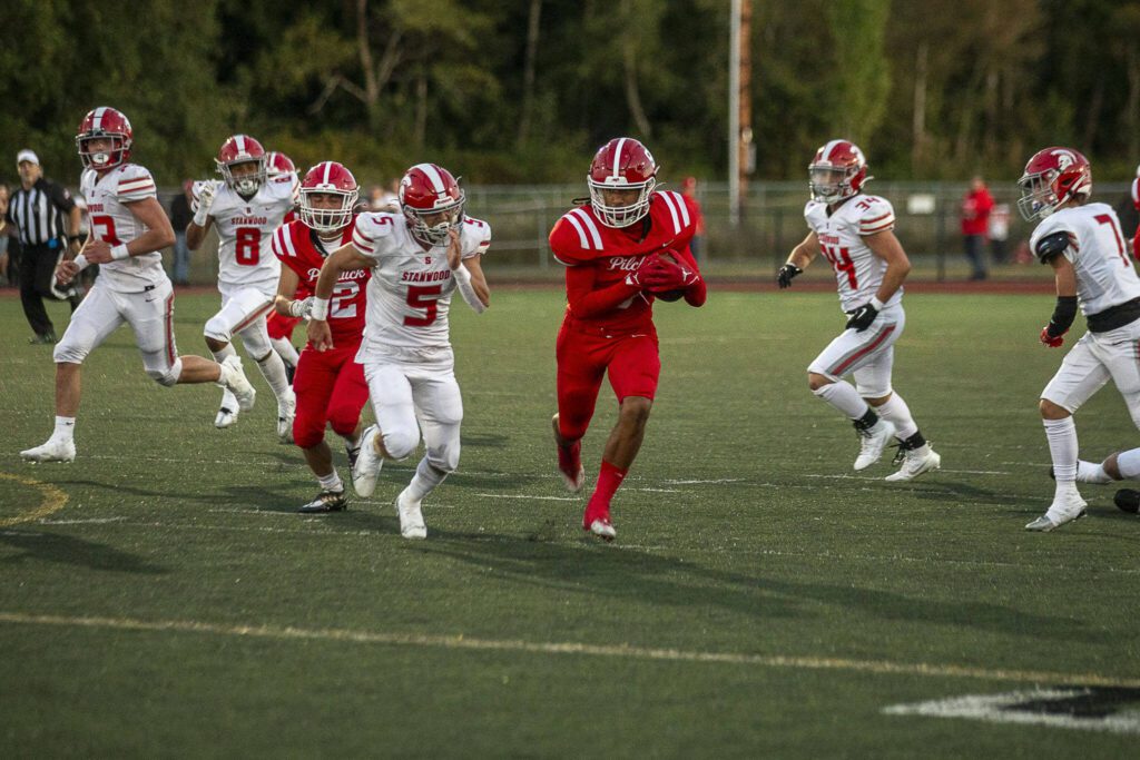 Marysville Pilchuck’s Dominik Kendrick (9) runs with the ball during a football game between Marysville Pilchuck and Stanwood at Marysville Pilchuck High School in Marysville, Washington on Friday, Sept. 8, 2023. Marysville Pilchuck takes the win, 36-7. (Annie Barker / The Herald)

