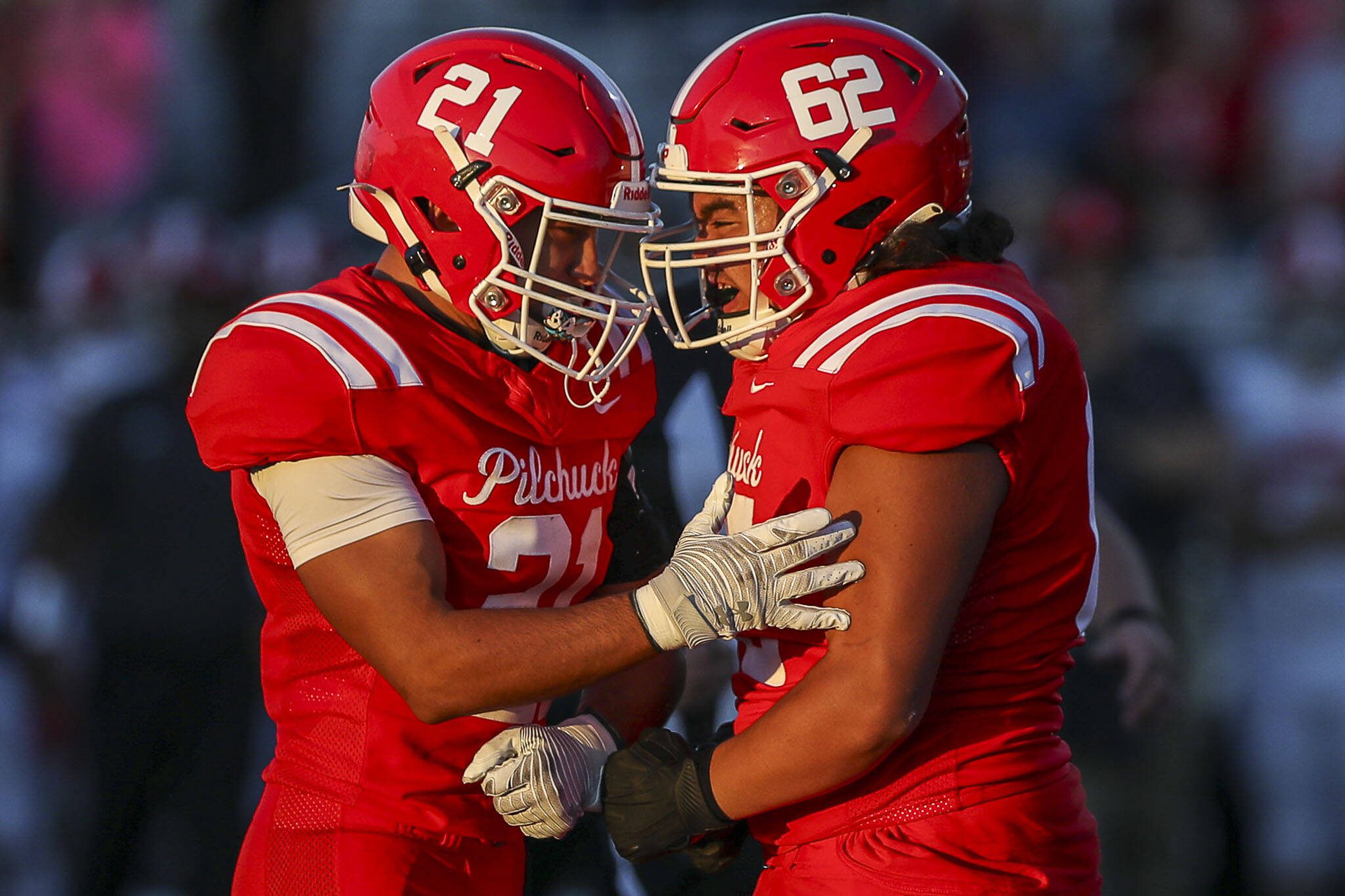 Marysville Pilchuck’s Kenai Sinaphet (21) and Braxton Leiu-Sopi (62) celebrate during a football game between Marysville Pilchuck and Stanwood at Marysville Pilchuck High School in Marysville, Washington on Friday, Sept. 8, 2023. Marysville Pilchuck takes the win, 36-7. (Annie Barker / The Herald)