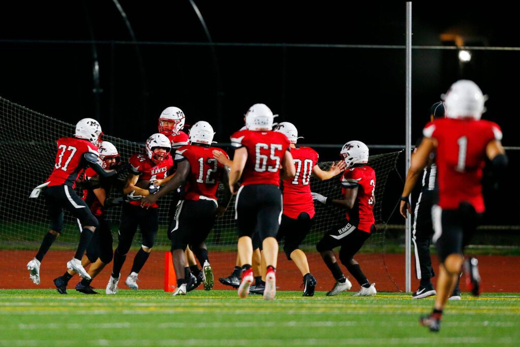 The Mountlake Terrace defense celebrates freshman Owen Boswell’s game-sealing pick-six against Snohomish on Friday, Sept. 8, 2023, at Edmonds Stadium in Edmonds, Washington. (Ryan Berry / The Herald)
