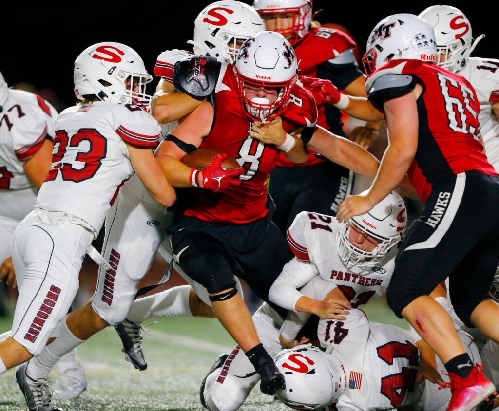 Mountlake Terrace sophomore Nate Brown carries a few defenders forward on a running play against Snohomish on Friday, Sept. 8, 2023, at Edmonds Stadium in Edmonds, Washington. (Ryan Berry / The Herald)
