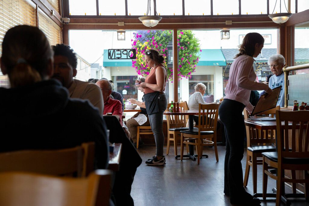 Service staff work the lunch hour during Chanterelle’s final day of business Tuesday, Sept. 12, 2023, in downtown Edmonds, Washington. (Ryan Berry / The Herald)
