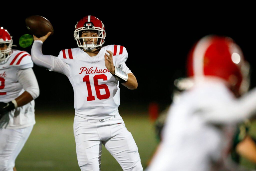 Marysville Pilchuck quarterback Luke Shoemaker steps into a pass after avoiding pressure against Marysville Getchell during the Berry Bowl on Friday, Sept. 15, 2023, at Quil Ceda Stadium in Marysville, Washington. The completion went for a long touchdown to receiver Dominik Kendrick. (Ryan Berry / The Herald)
