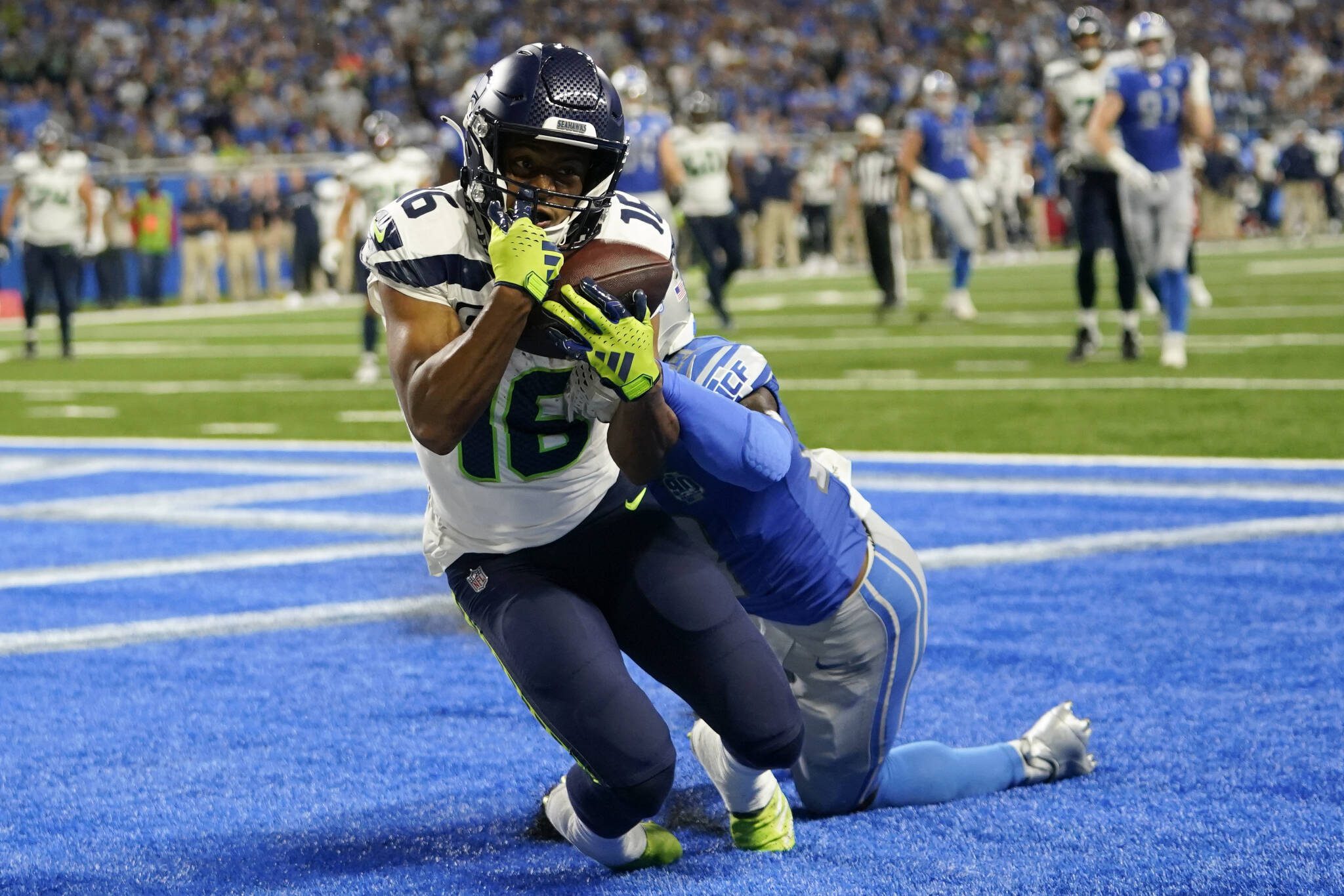 Seahawks wide receiver Tyler Lockett (16) catches a 3-yard touchdown pass in front Lions cornerback Jerry Jacobs during the second half of a game Sunday in Detroit. (AP Photo/Paul Sancya)