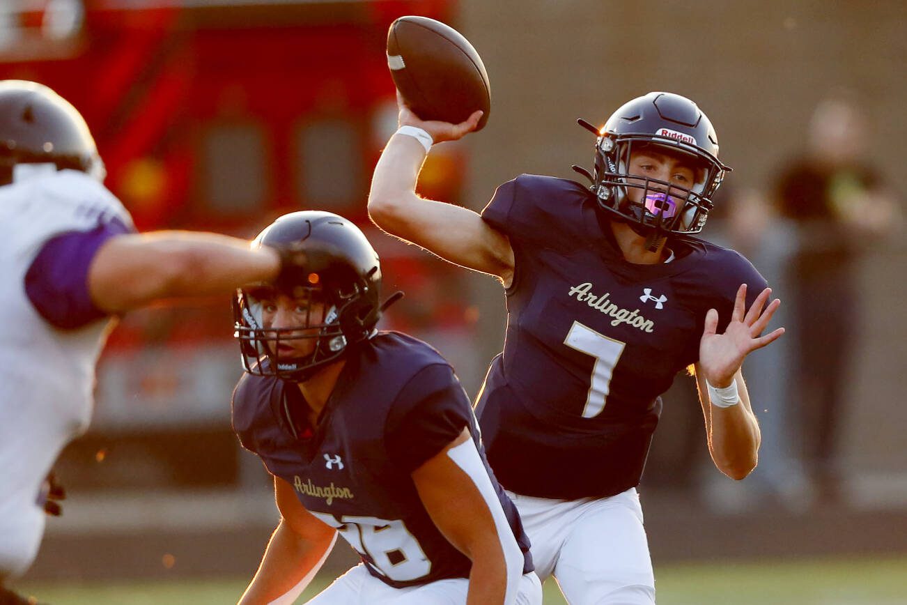 Arlington junior quarterback Leyton Martin throws a short pass during the second quarter of the season opener against Kamiak on Friday, Sep. 1, 2023, at Arlington High School in Arlington, Washington. (Ryan Berry / The Herald)