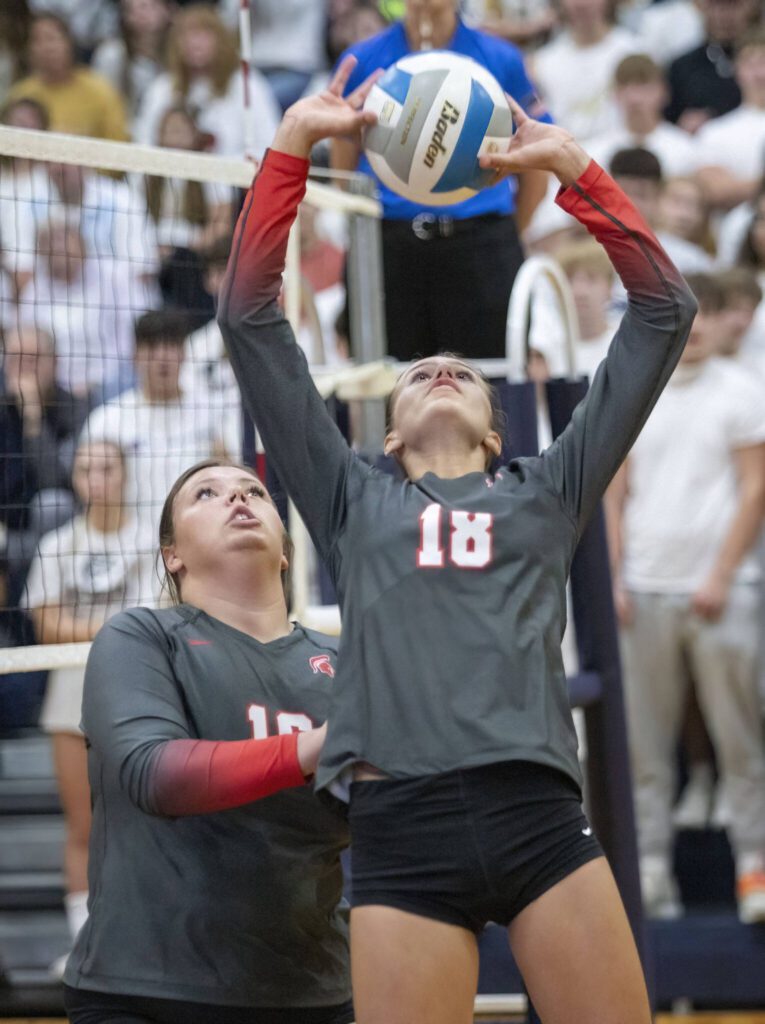 Stanwood’s Cadence Simpson, left, and Whitney Longspaugh, right, collide while Longspaugh tries to set the ball during the game against Arlington on Tuesday, Sept. 19, 2023 in Arlington, Washington. (Olivia Vanni / The Herald)
