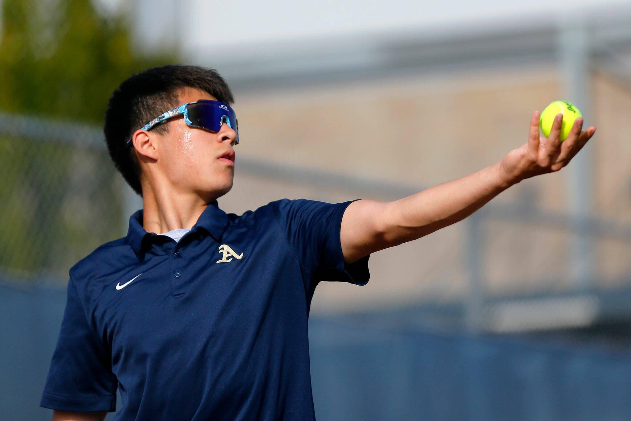 Arlington’s Robbie Balderas serves to an opponent during a matchup with Everett High on Monday, Sept. 18, 2023, at his school’s home court in Arlington, Washington. (Ryan Berry / The Herald)