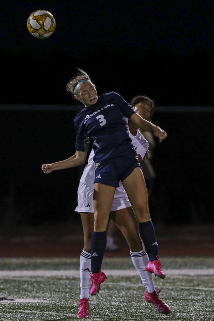 Glacier Peak’s Ella Seelhoff (3) heads the ball during a girls soccer game between Glacier Peak and Lake Stevens at Glacier Peak High School in Snohomish, Washington on Thursday, Sept. 21, 2023. Lake Stevens won, 2-1. (Annie Barker / The Herald)
