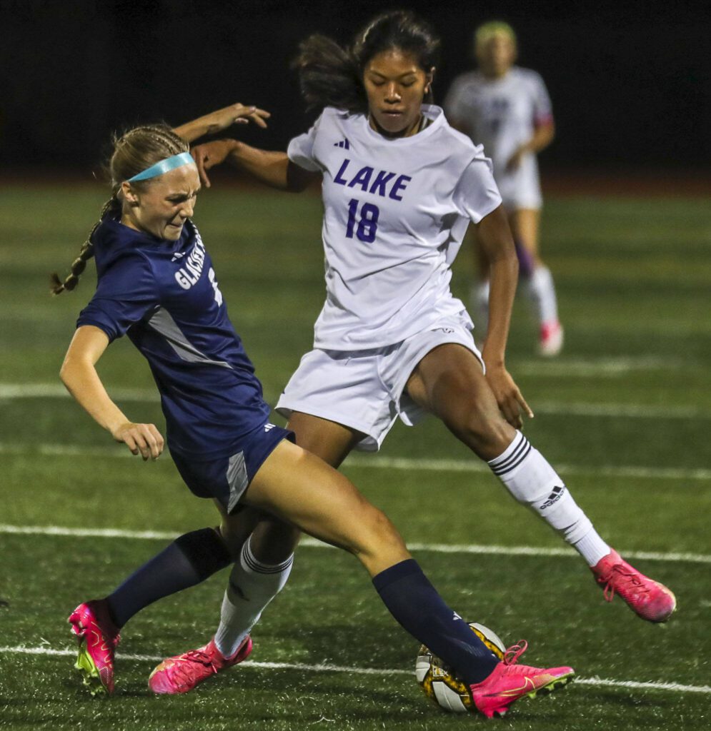 Glacier Peak’s Ella Seelhoff (3) and Lake Stevens’ Noelani Tupua (18) fight for the ball during a girls soccer game between Glacier Peak and Lake Stevens at Glacier Peak High School in Snohomish, Washington on Thursday, Sept. 21, 2023. Lake Stevens won, 2-1. (Annie Barker / The Herald)
