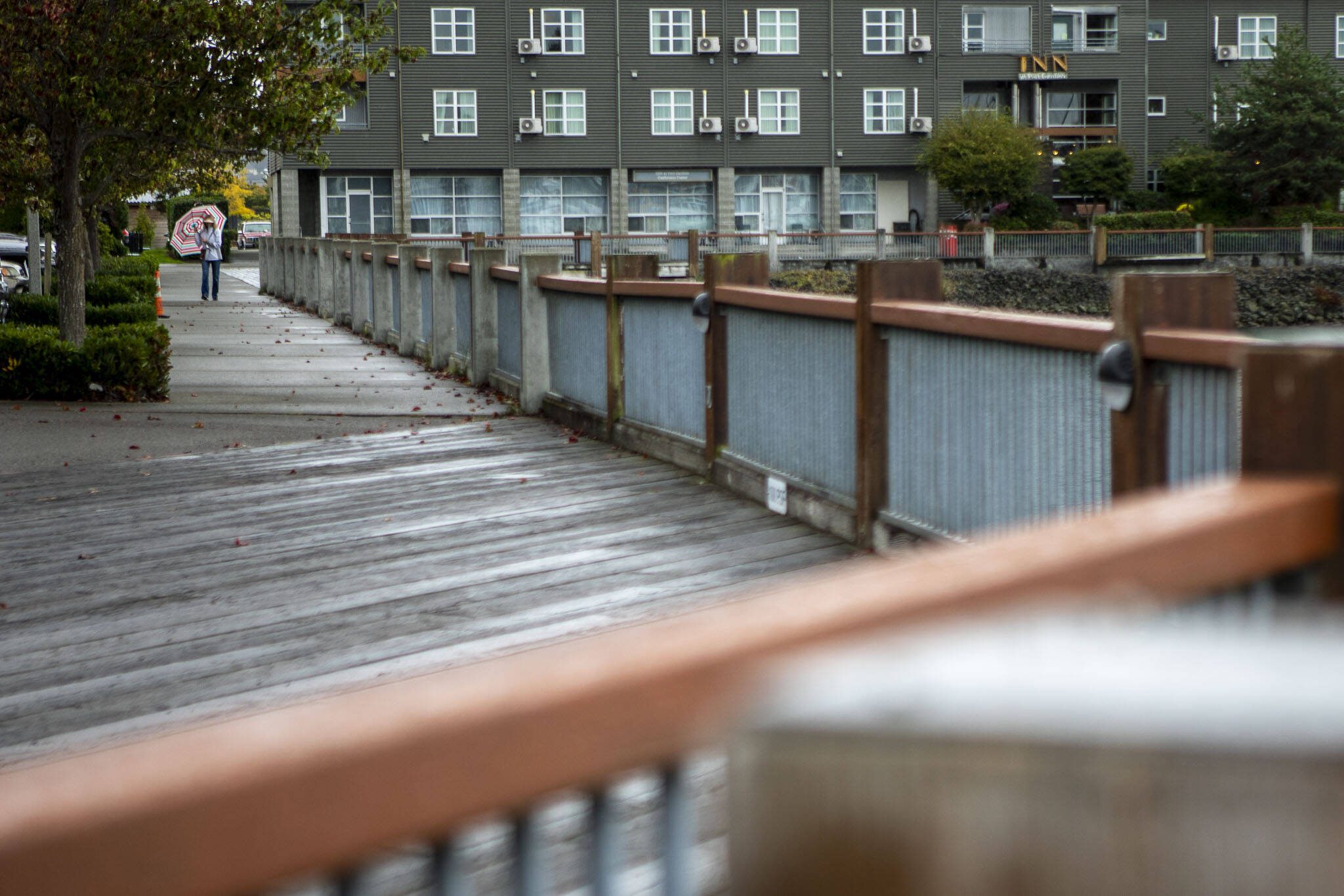 A person walks in the rain at the Port of Everett in Everett, Washington on Saturday, Sept. 23, 2023. (Annie Barker / The Herald)