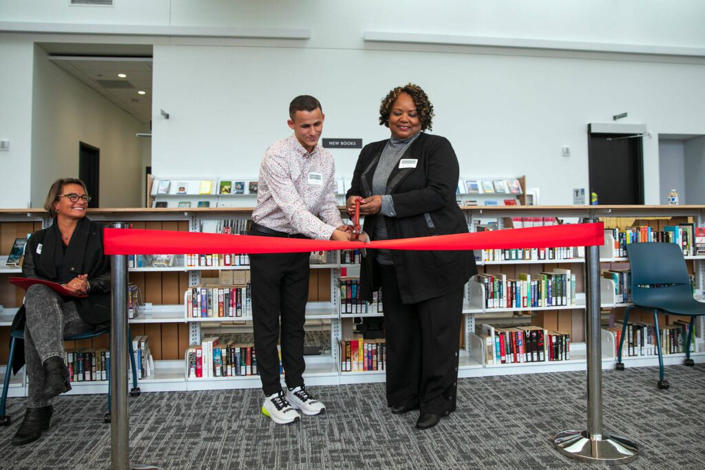 Student Vitalli Shvets and college President Dr. Chemene Crawford cut a ceremonial ribbon at the new Cascade Learning Center on Thursday, Sept. 28, 2023, at Everett Community College in Everett, Washington. (Ryan Berry / The Herald)
