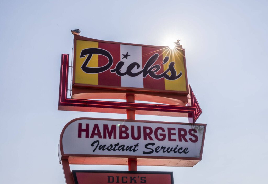 Two seagulls sit on top of the Dick’s sign on Friday, Sept. 22, 2023 in Edmonds, Washington. (Olivia Vanni / The Herald)
