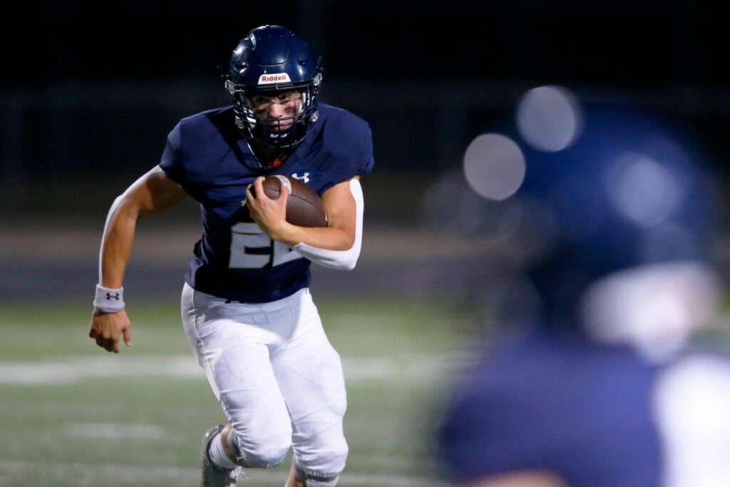 Arlington running back Caleb Reed looks for space against Ferndale on Friday, Sept. 22, 2023, at Arlington High School in Arlington, Washington. (Ryan Berry / The Herald)
