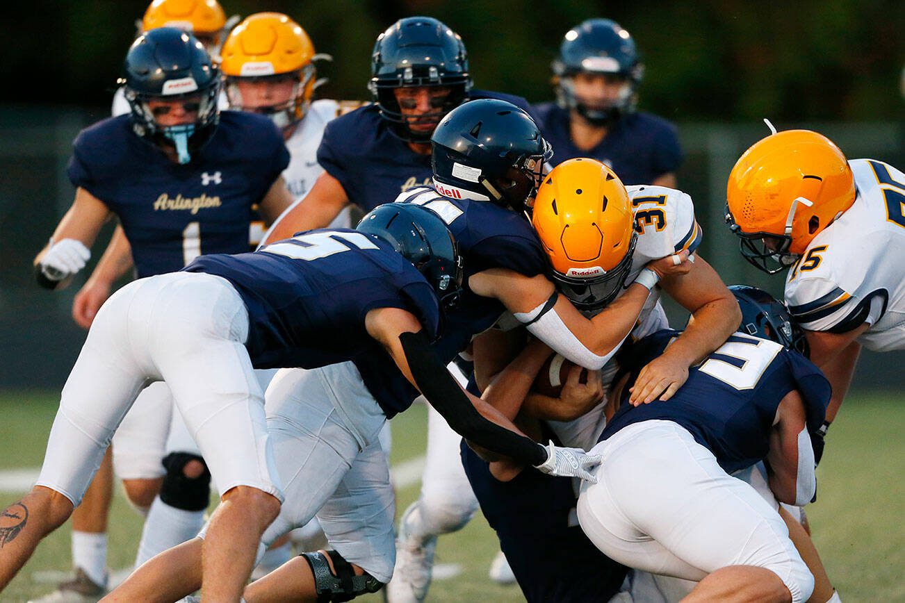 Arlington’s defense stuffs Ferndale running back Talan Bungard on Friday, Sept. 22, 2023, at Arlington High School in Arlington, Washington. (Ryan Berry / The Herald)