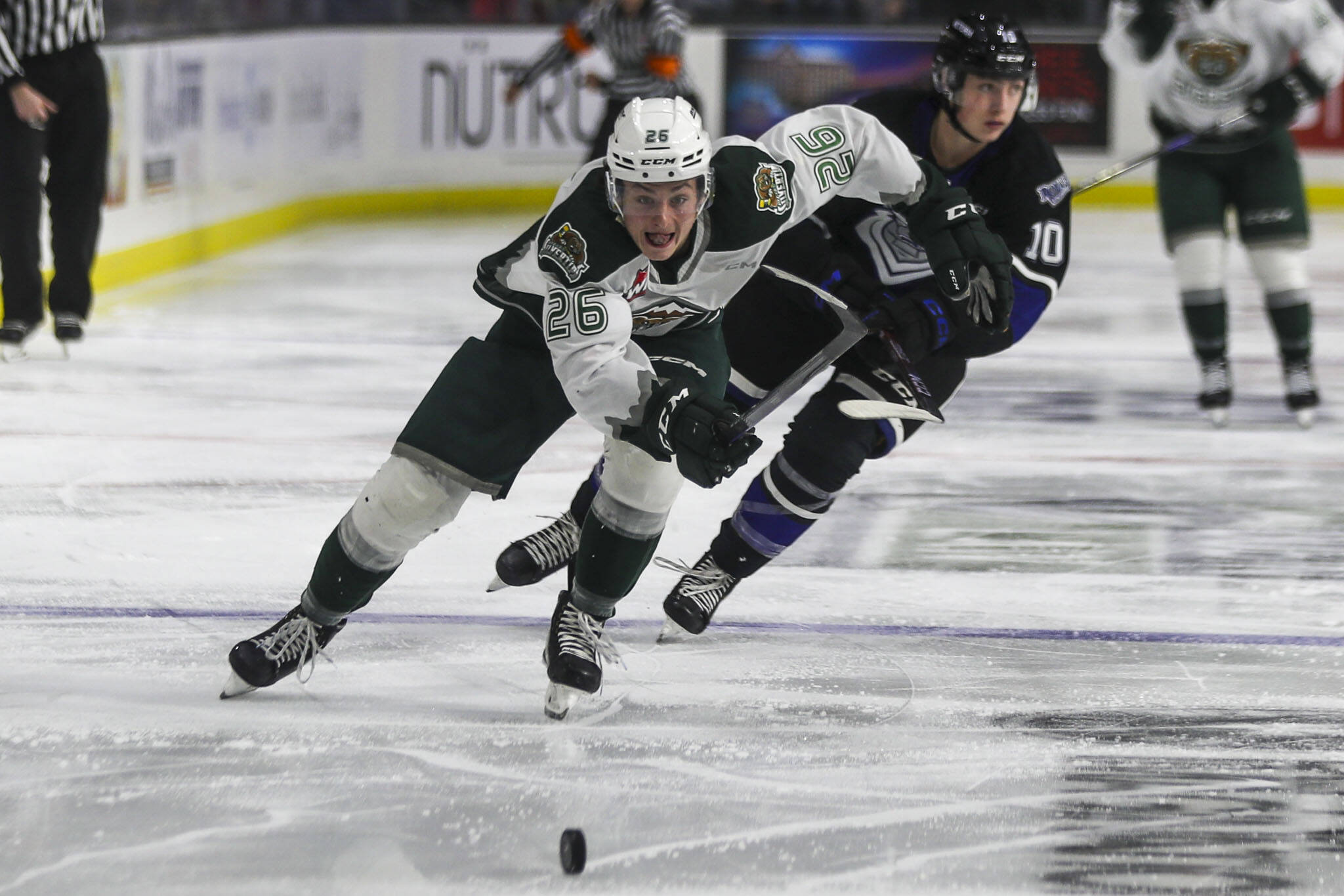Silvertips’ Andrew Petruk (26) fights for the puck during a game between the Everett Silvertips and Victoria Royals at the Angel of the Winds Arena on Saturday, Sept. 23, 2023. The Silvertips won, 5-3. (Annie Barker / The Herald)