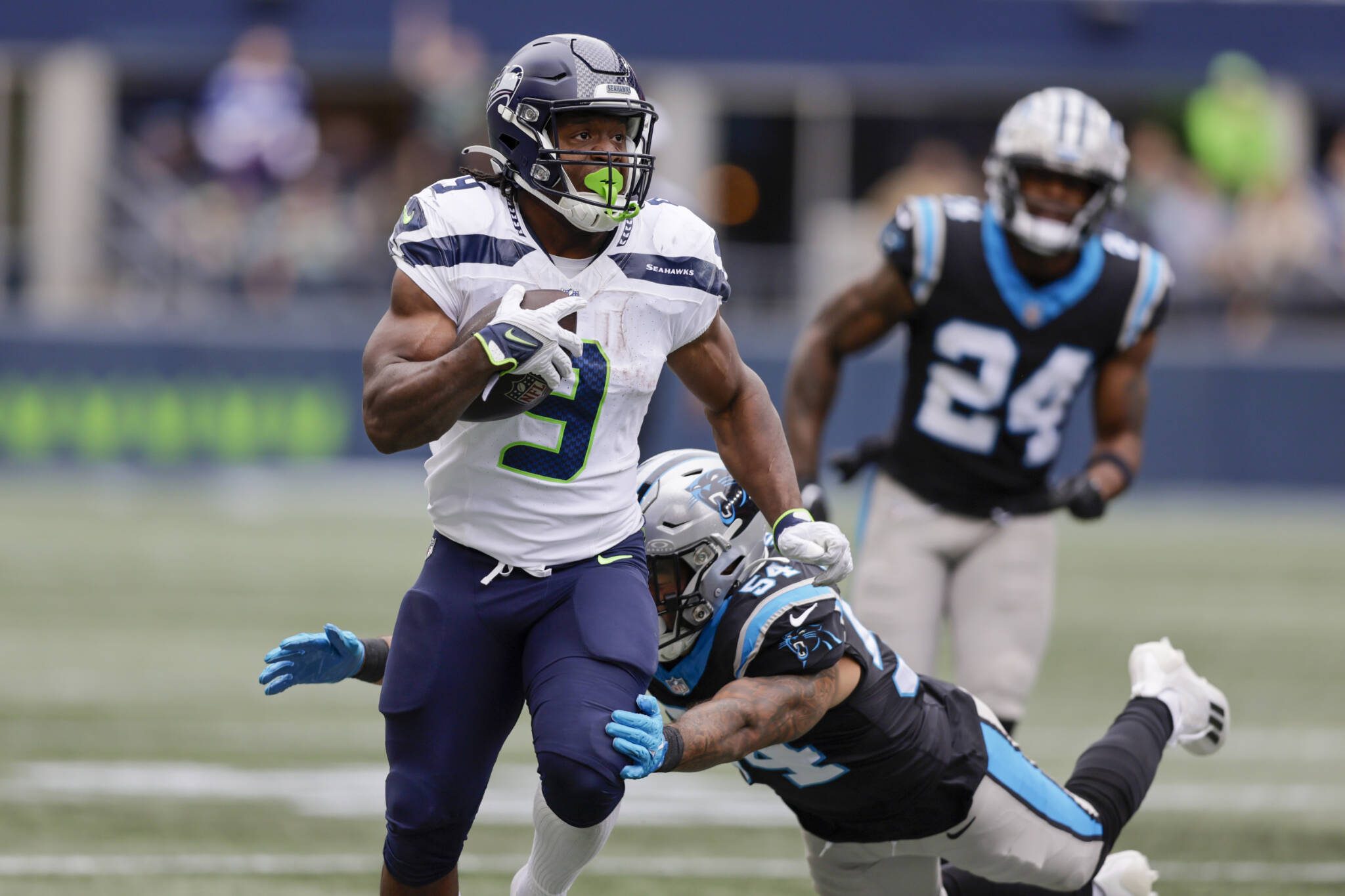 Seahawks running back Kenneth Walker III runs past Panthers linebacker Kamu Grugier-Hill during the first half of a game Sunday in Seattle. (AP Photo/John Froschauer)