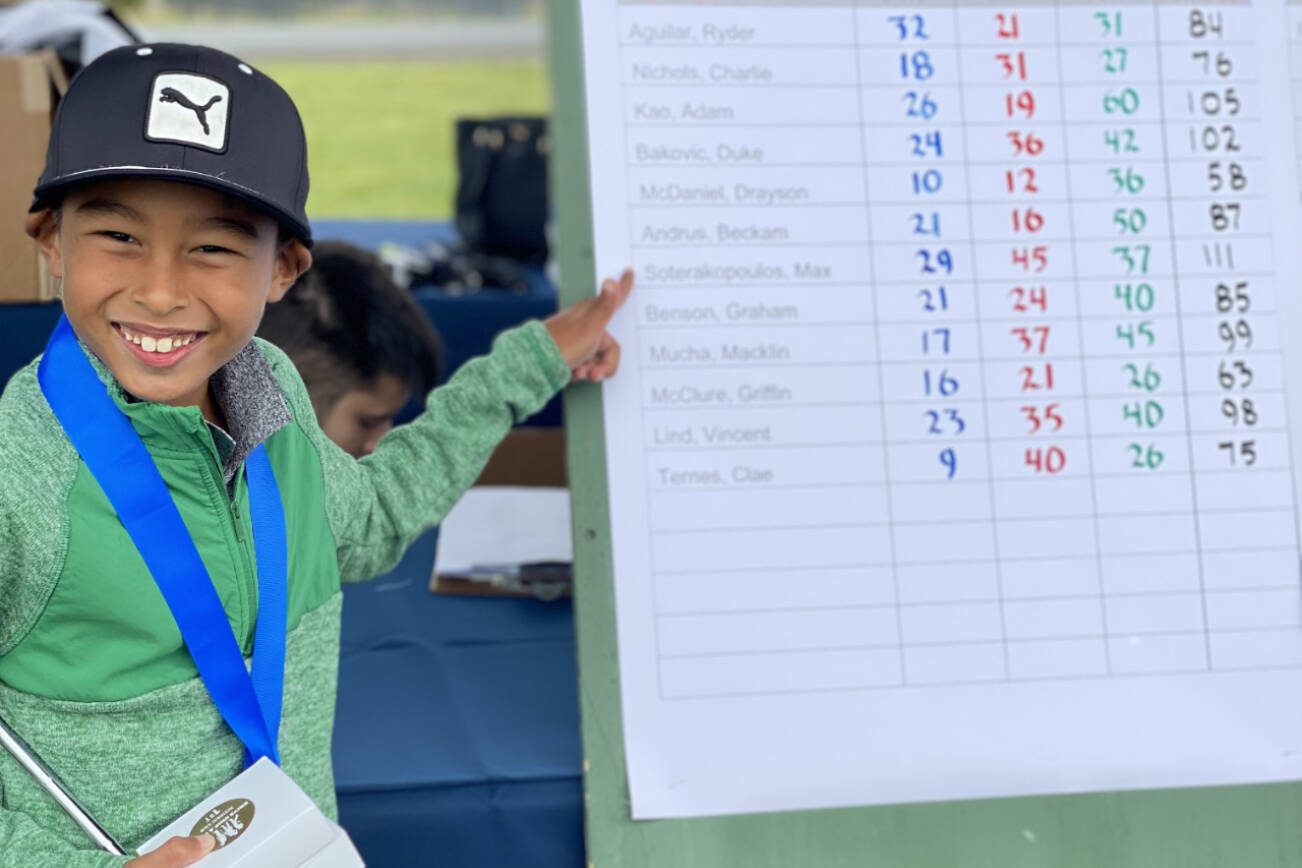 Everett's Max Soterakopoulos points to his name on the leaderboard after winning his division the Regional Qualifier for Drive, Chip and Putt, held last Saturday at Chambers Bay Golf Course in University Place. (Photo coutesy of Chris Soterakopoulos)