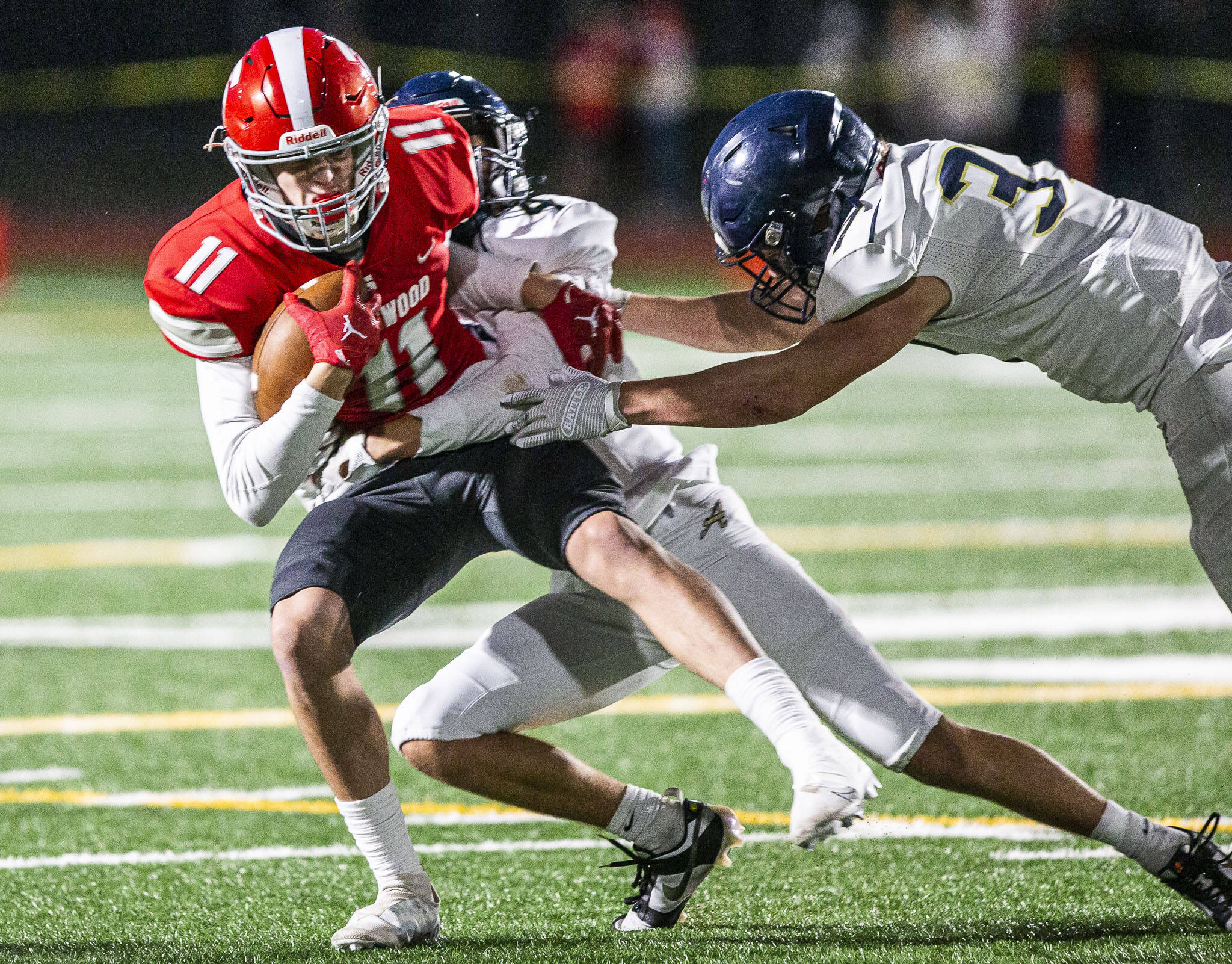 Stanwood’s Elias Caniglia is tackled by Arlington’s Jake Willis during the game on Friday, Sept. 29, 2023 in Stanwood, Washington. (Olivia Vanni / The Herald)