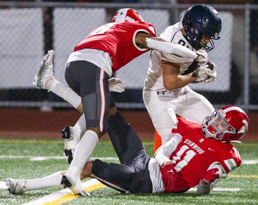 Arlington’s Stevie Balderas runs through multiple tackles by Stanwood players during the game on Friday, Sept. 29, 2023 in Stanwood, Washington. (Olivia Vanni / The Herald)
