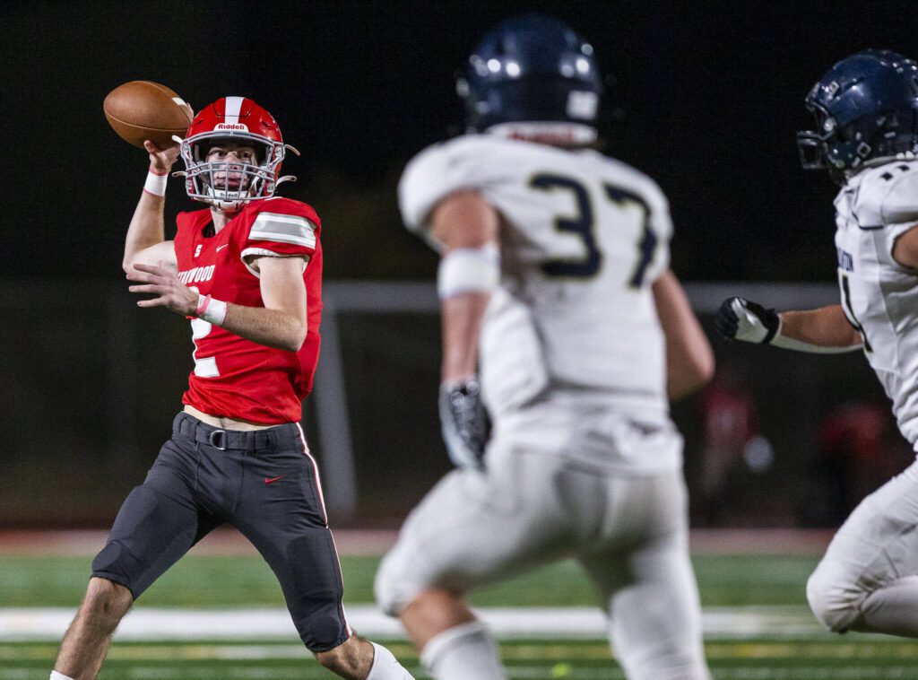 Stanwood’s Luke Brennan throws the ball while on the run during the game against Arlington on Friday, Sept. 29, 2023 in Stanwood, Washington. (Olivia Vanni / The Herald)
