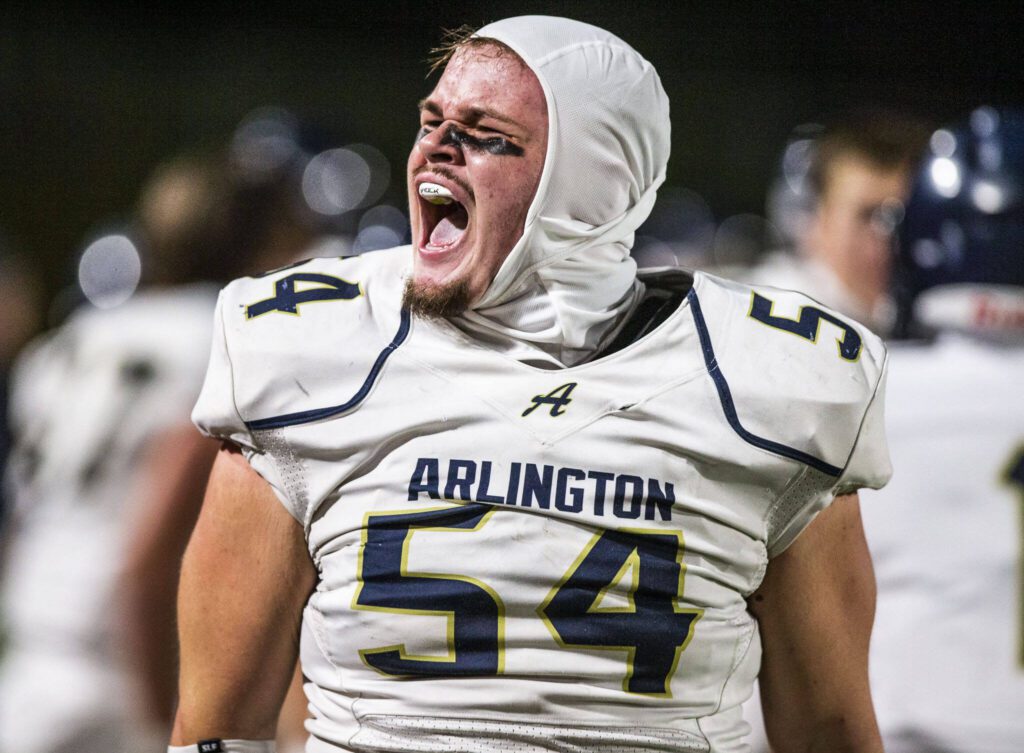 Arlington’s Nolan Welch-Downing yells after forcing a turnover during the game against Stanwood on Friday, Sept. 29, 2023 in Stanwood, Washington. (Olivia Vanni / The Herald)
