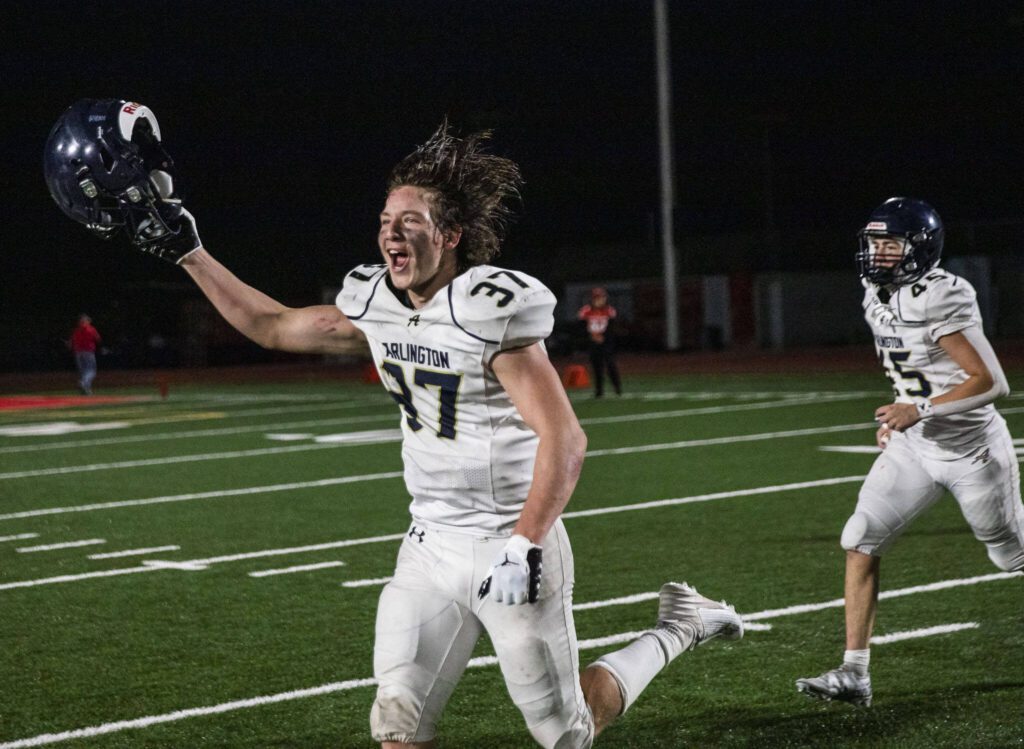 Arlington’s Kobi Spady runs toward the sidelines to celebrate beating Stanwood for the Stilly Cup on Friday, Sept. 29, 2023 in Stanwood, Washington. (Olivia Vanni / The Herald)
