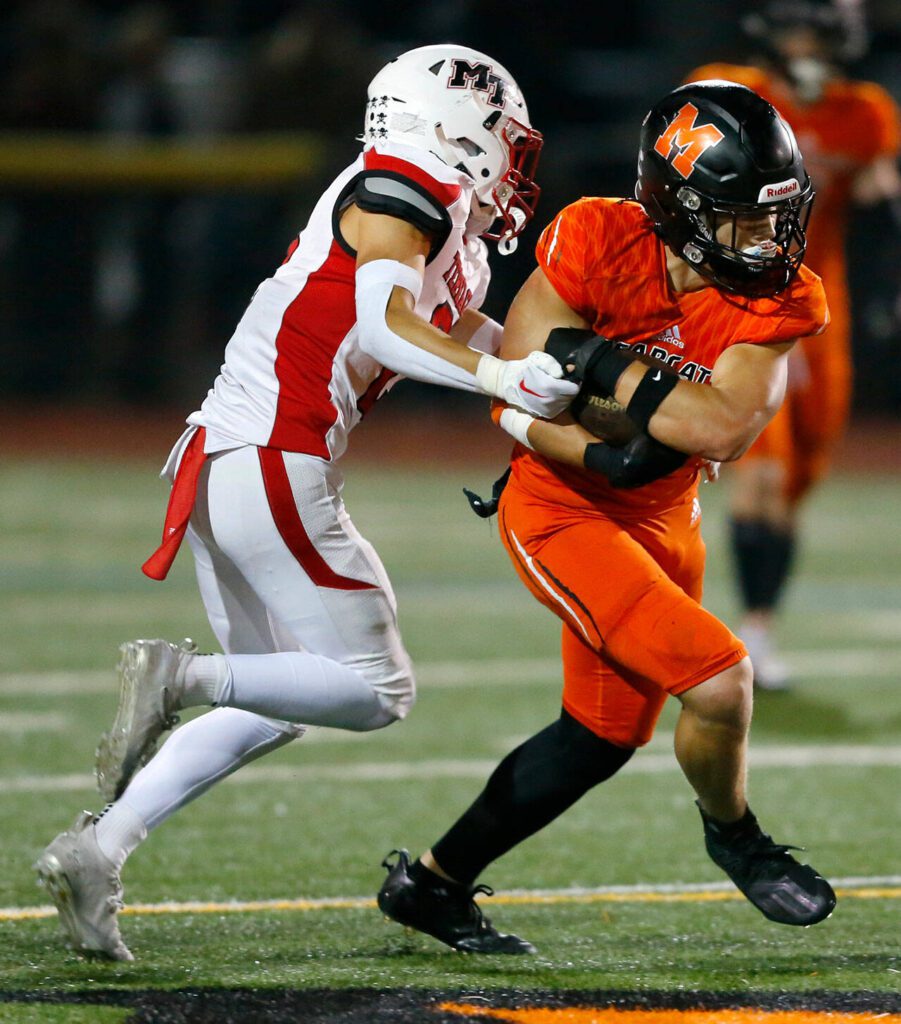Monroe captain Gavin Ranz fights for extra yards on a handoff against Mountlake Terrace on Friday, Sept. 29, 2023, at Monroe High School in Monroe, Washington. (Ryan Berry / The Herald)
