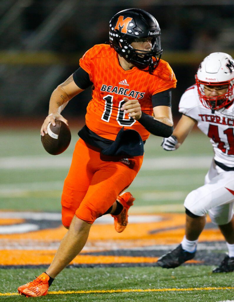 Monroe’s Blake Springer rolls out of the pocket before firing downfield against Mountlake Terrace on Friday, Sept. 29, 2023, at Monroe High School in Monroe, Washington. (Ryan Berry / The Herald)
