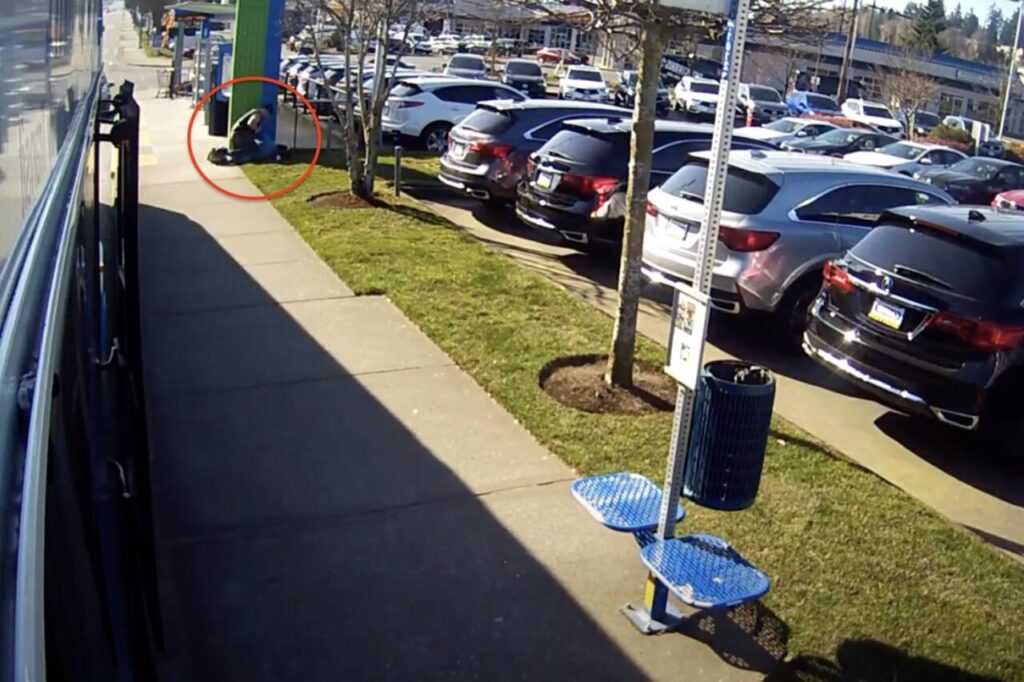 Surveillance footage shows Sheriff’s deputy Matt Lease pinning Sharron Wilson to the ground at the bus stop in Edmonds on March 21, 2020.
